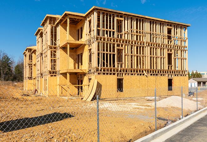 a construction site enclosed by temporary chain link fences, ensuring safety for workers and pedestrians in Harper Woods MI